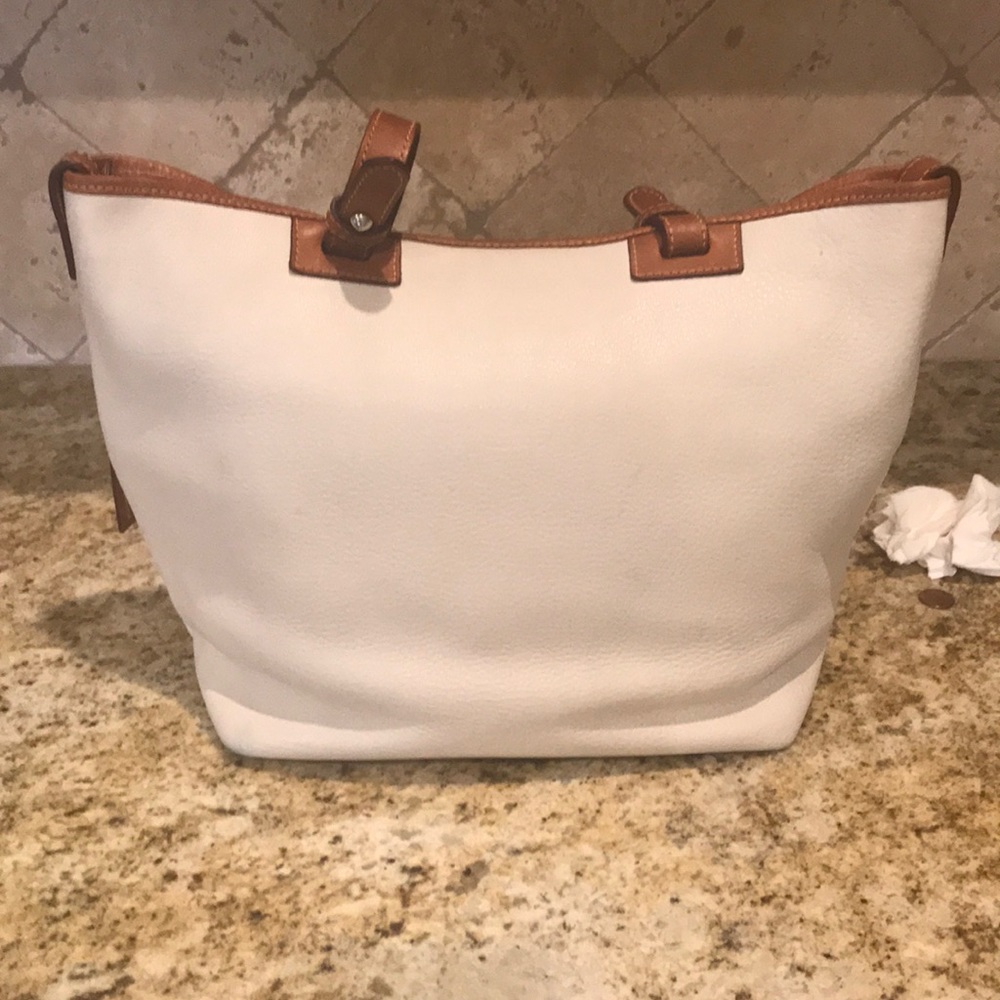Large cream Dooney and Bourke satchel with front zip pockets